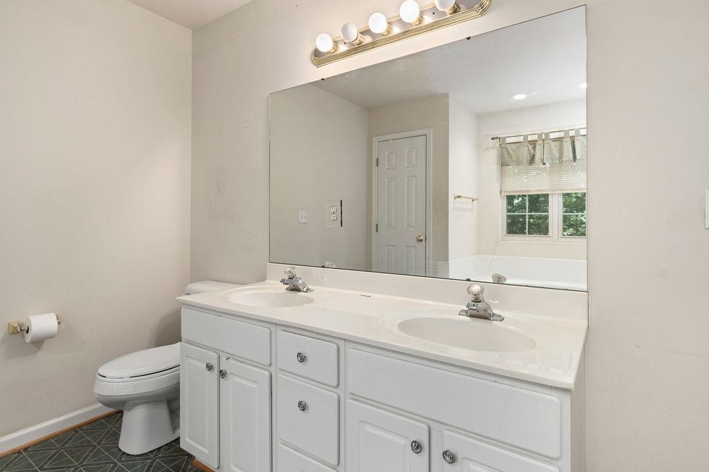 661 Jefferson Drive Palmyra, VA 22963 - Photo 32 of 41 a bathroom with a sink toilet and mirror
