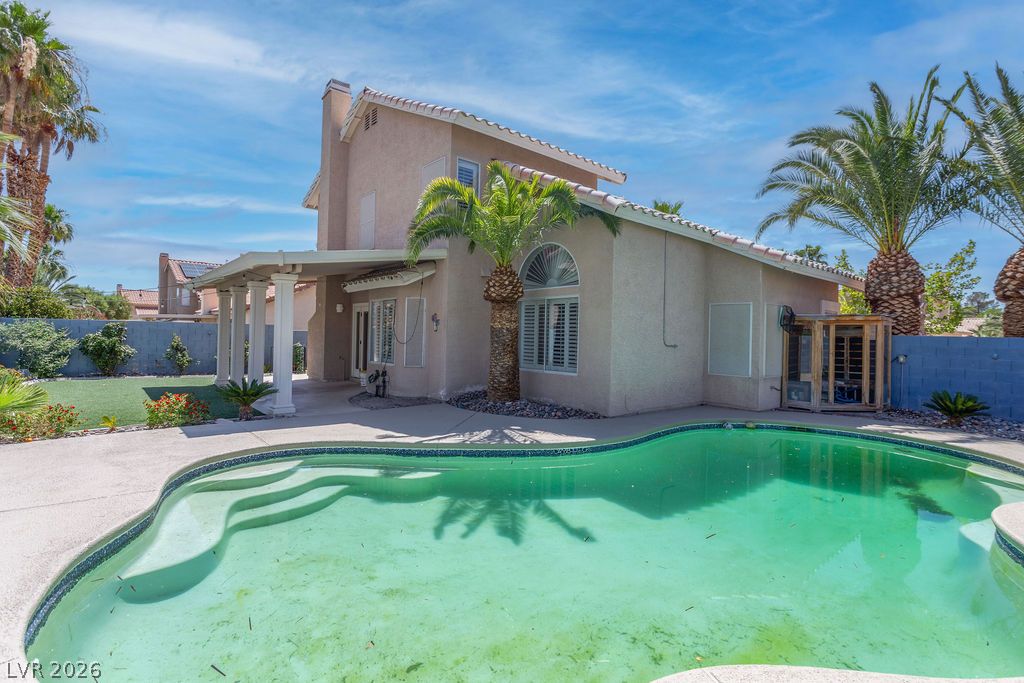 1416 Walstone Road North Las Vegas, NV 89031 - Photo 46 of 47 A spacious backyard oasis features an inviting inground pool and a covered patio for outdoor entertaining.