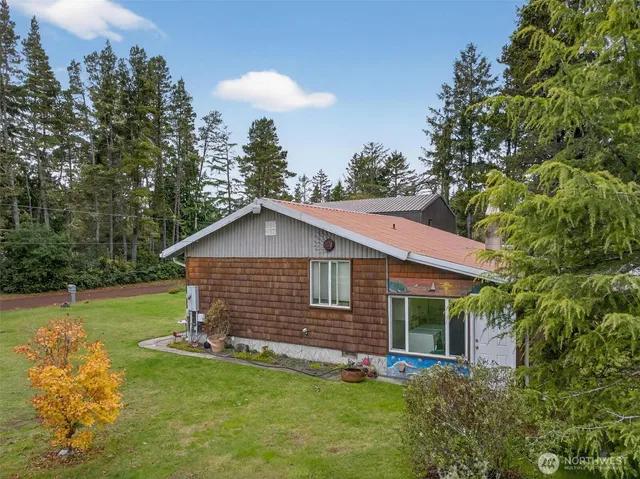 a view of a house with a yard and sitting area