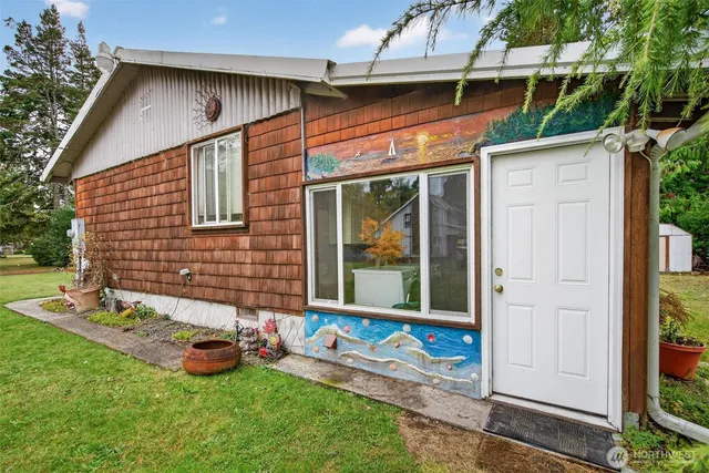 a view of a backyard with table and chairs and potted plants