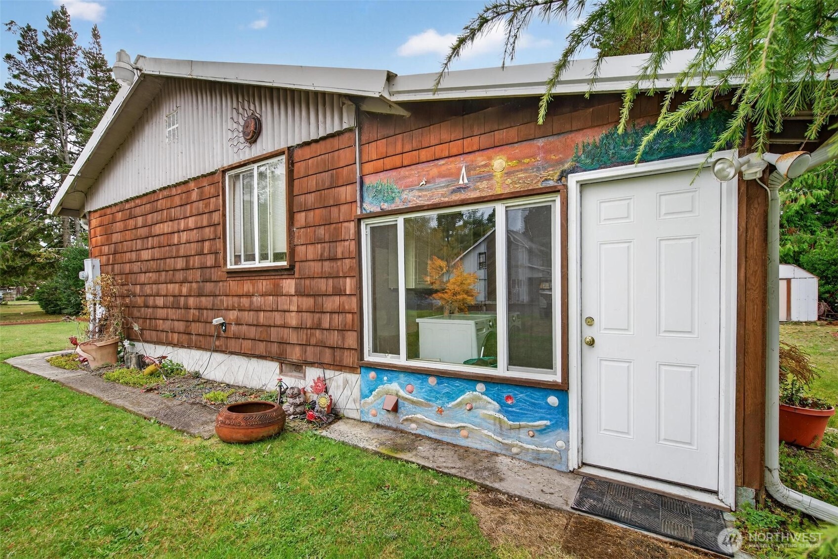 27501 R Lane Ocean Park, WA 98640 - Photo 13 of 40 a view of a backyard with table and chairs and potted plants