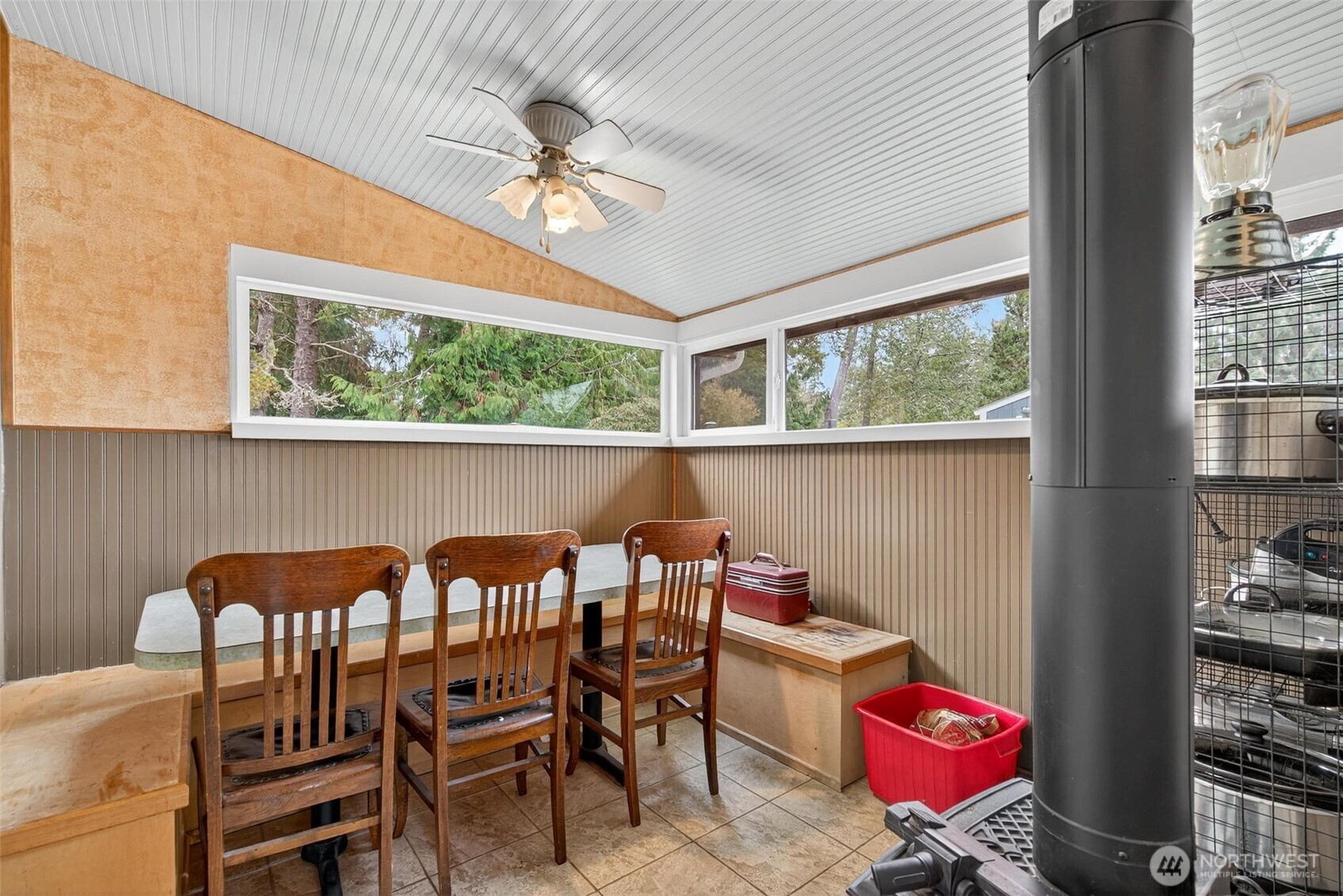 27501 R Lane Ocean Park, WA 98640 - Photo 25 of 40 a view of a dining room with furniture a chandelier and large windows