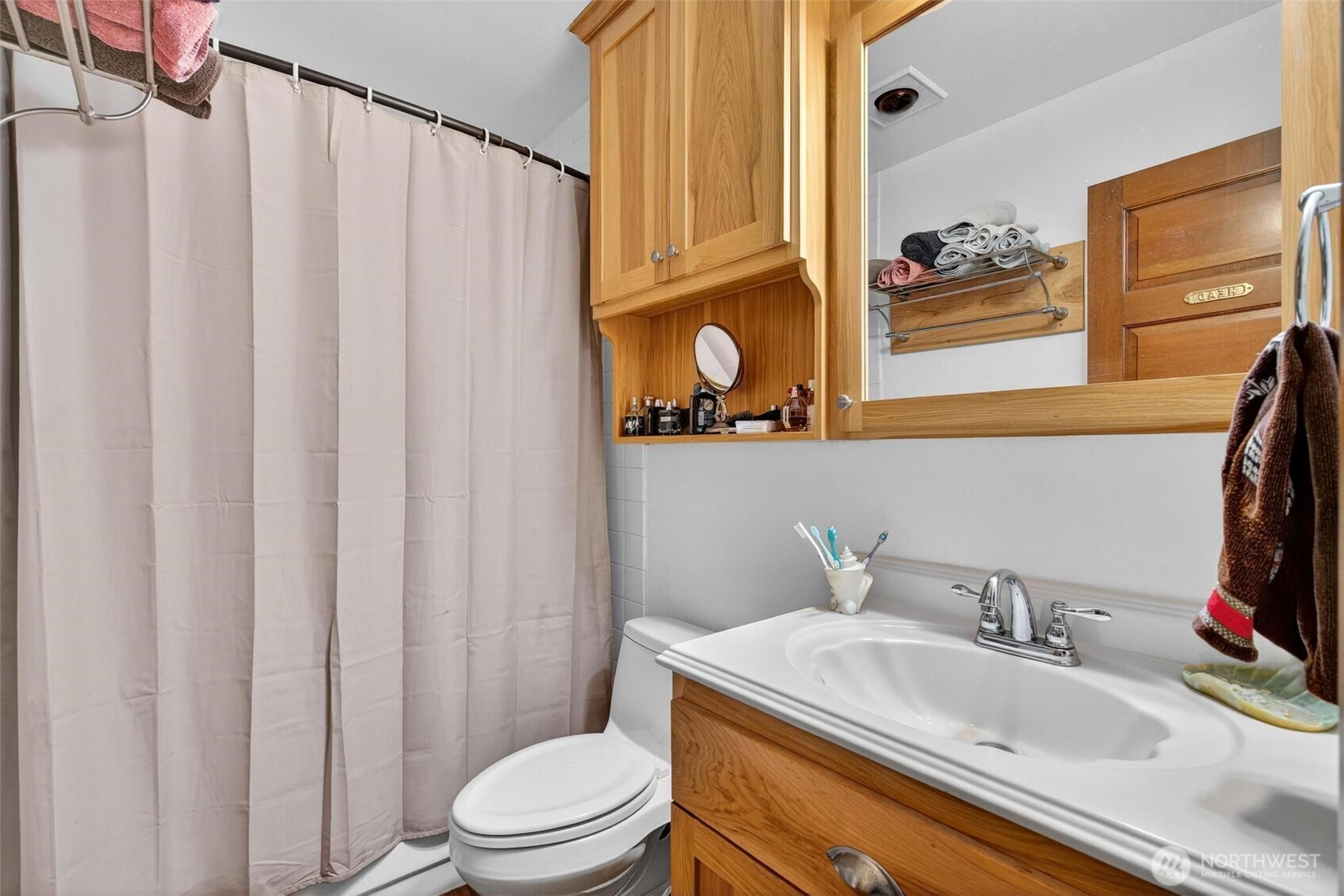 27501 R Lane Ocean Park, WA 98640 - Photo 30 of 40 a bathroom with a sink a toilet and shower curtain