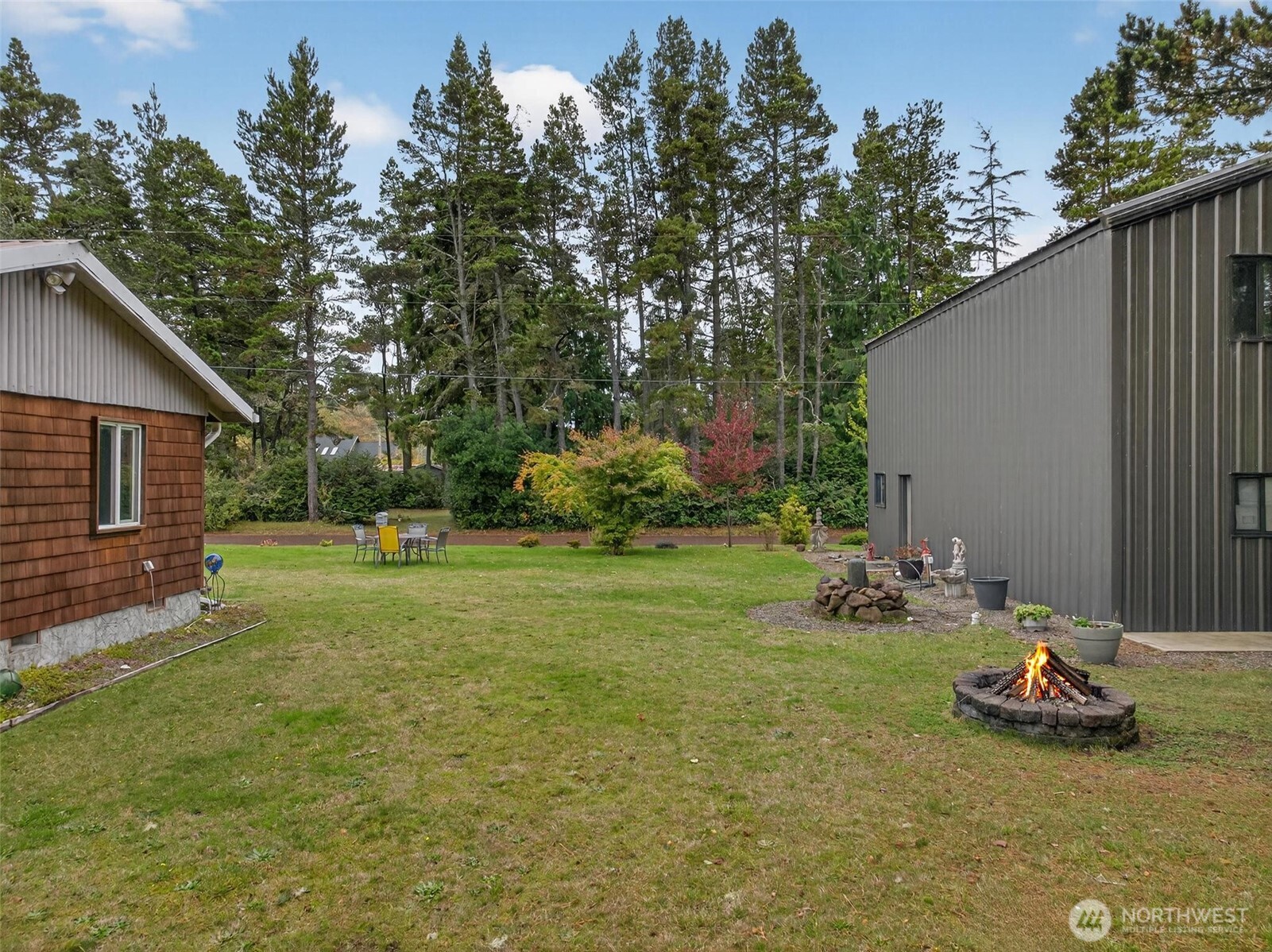 27501 R Lane Ocean Park, WA 98640 - Photo 8 of 40 a view of a backyard with plants and brick wall