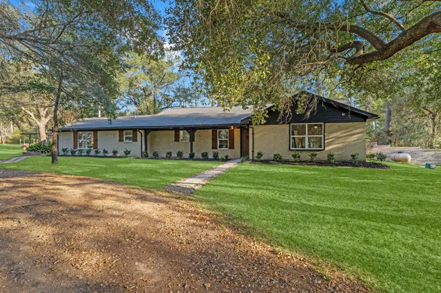 a front view of a house with a garden