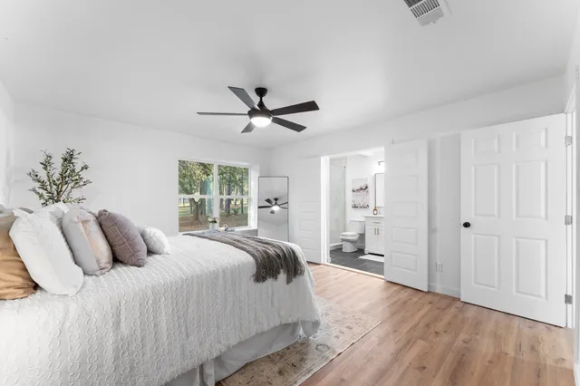 a bathroom with a double vanity sink toilet and shower