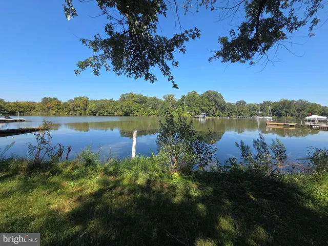a view of a lake with houses in the back