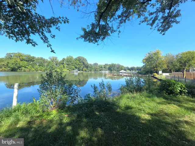 a view of a lake with houses in the back