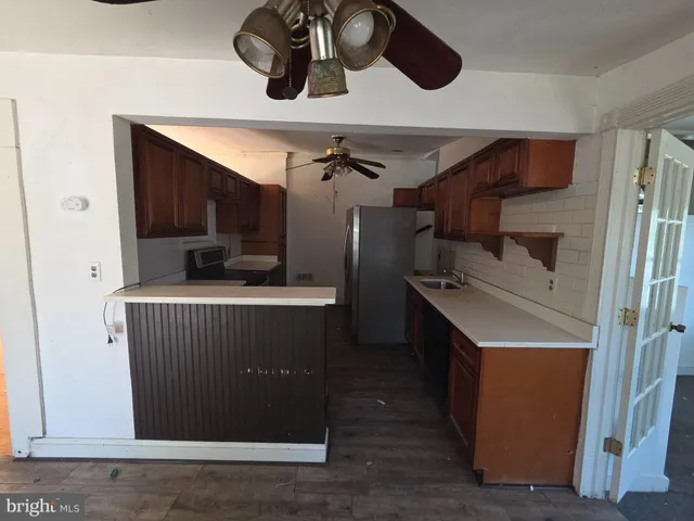 a kitchen with a refrigerator and cabinets