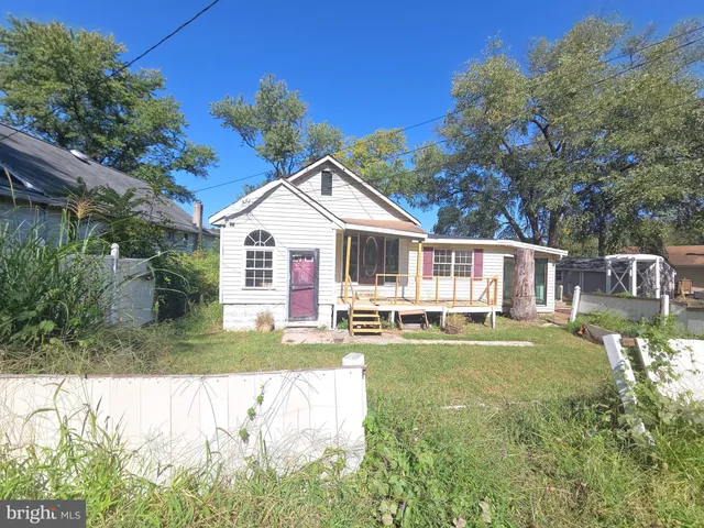 a front view of a house with a yard table and chairs