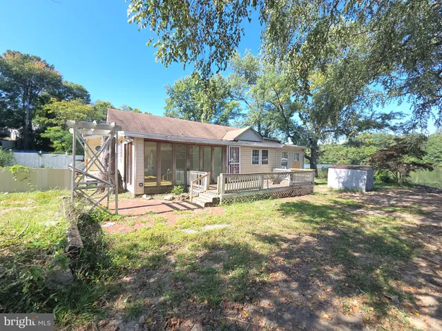 a front view of a house with swimming pool having outdoor seating