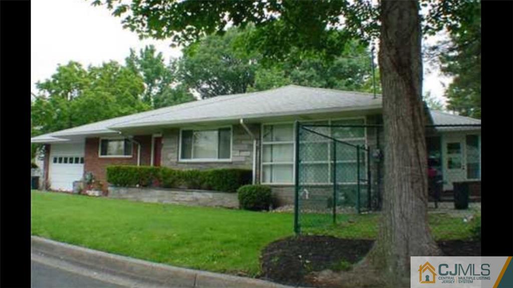 100 Dover Road Colonia, NJ 07067 - Photo 1 of 25 a view of a house with a yard and plants