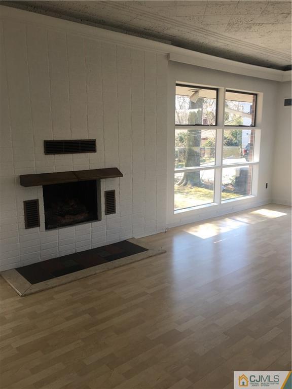 100 Dover Road Colonia, NJ 07067 - Photo 2 of 25 a view of an empty room with wooden floor and a window