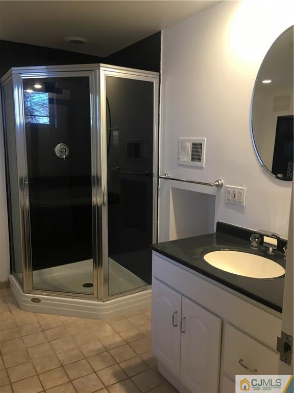 100 Dover Road Colonia, NJ 07067 - Photo 12 of 25 a bathroom with a sink a toilet and shower