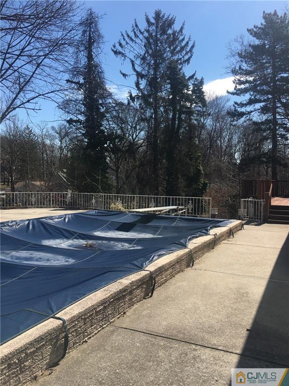 100 Dover Road Colonia, NJ 07067 - Photo 14 of 25 a view of swimming pool with wooden fence