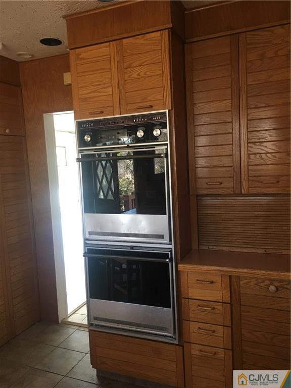 100 Dover Road Colonia, NJ 07067 - Photo 18 of 25 a stove top oven sitting inside of a kitchen