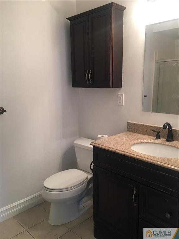 100 Dover Road Colonia, NJ 07067 - Photo 3 of 25 a bathroom with a granite countertop toilet sink and mirror
