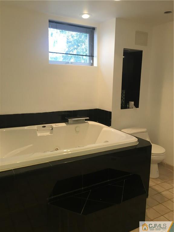100 Dover Road Colonia, NJ 07067 - Photo 25 of 25 a bathroom with a sink and a mirror