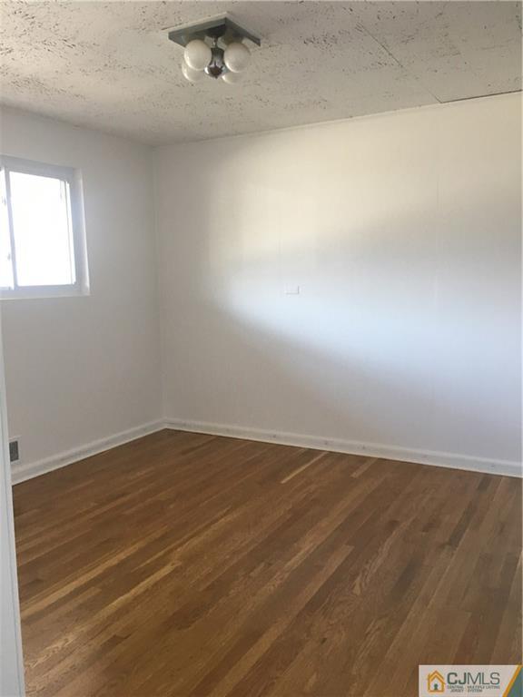 100 Dover Road Colonia, NJ 07067 - Photo 4 of 25 en empty room with wooden floor