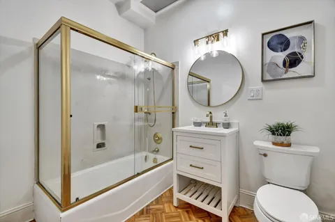a bathroom with a toilet a sink and a mirror