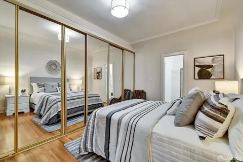 a bedroom with a bed and a mirror