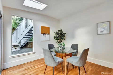a dining room with furniture and wooden floor