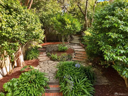 a view of house with a sink and potted plants