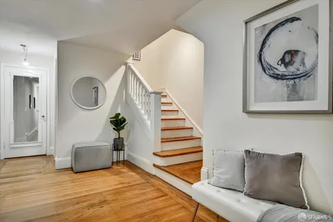 a living room with furniture and a mirror