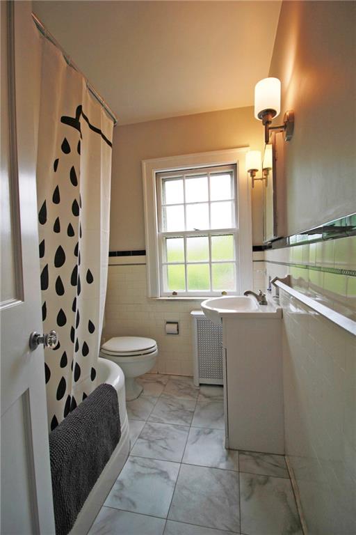 406 Olympia Road Pittsburgh, PA 15211 - Photo 13 of 13 The neutral bathroom in timeless black and white has been freshened with a new vanity and floor.