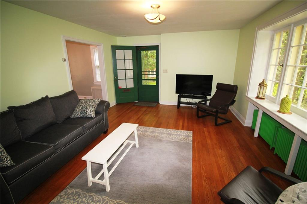 406 Olympia Road Pittsburgh, PA 15211 - Photo 5 of 13 A view of the living room as you walk down the stairs.