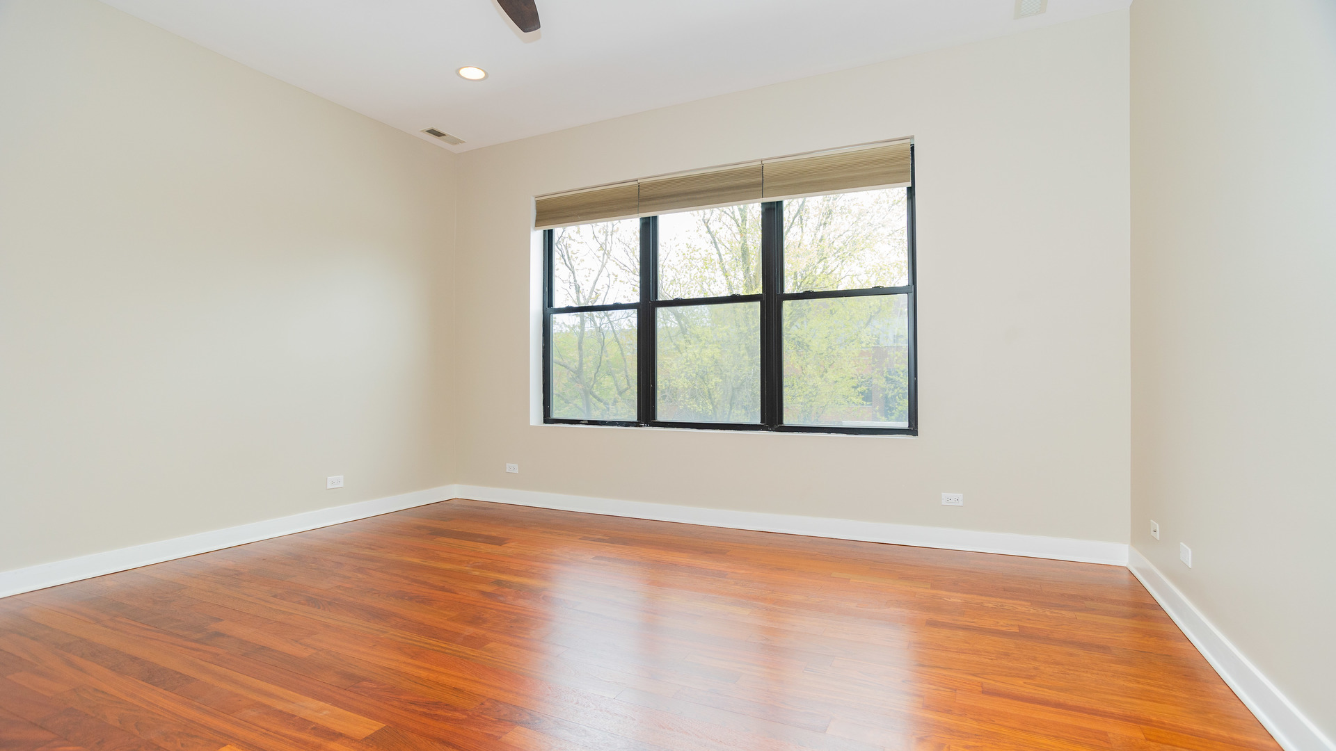 Undisclosed Address Chicago, IL 60645 - Photo 12 of 18 an empty room with wooden floor and windows