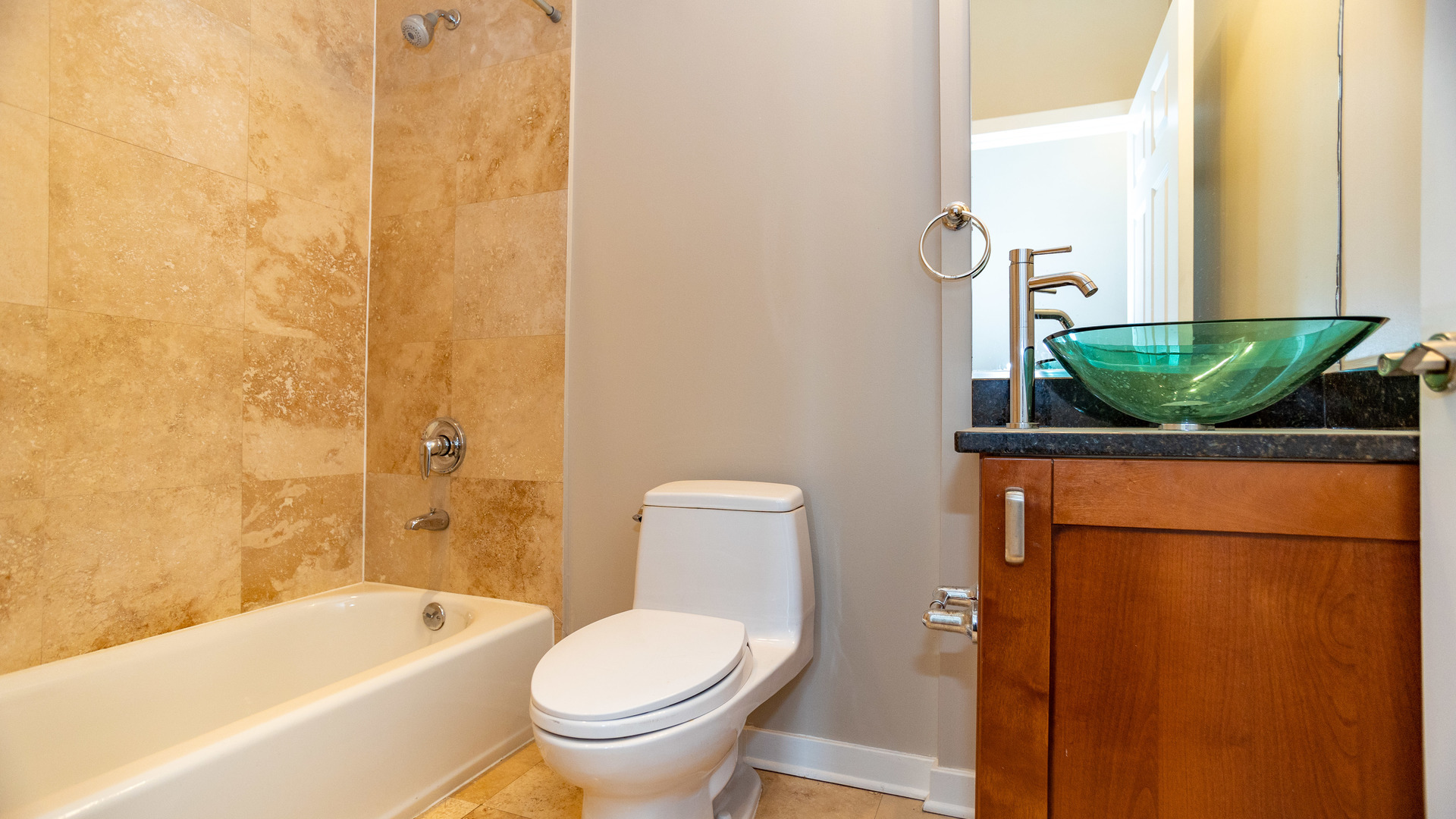 Undisclosed Address Chicago, IL 60645 - Photo 14 of 18 a bathroom with a granite countertop sink and a bathtub