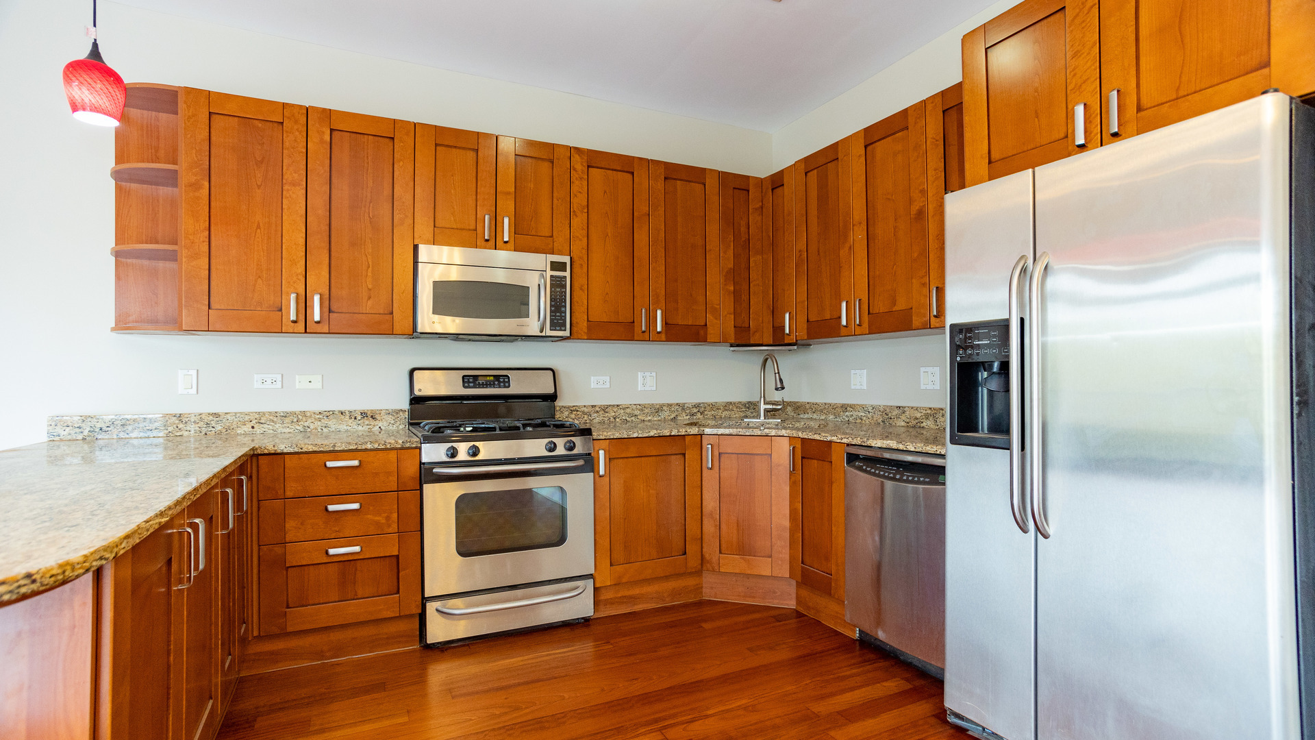 Undisclosed Address Chicago, IL 60645 - Photo 6 of 18 a kitchen with granite countertop wooden cabinets and stainless steel appliances