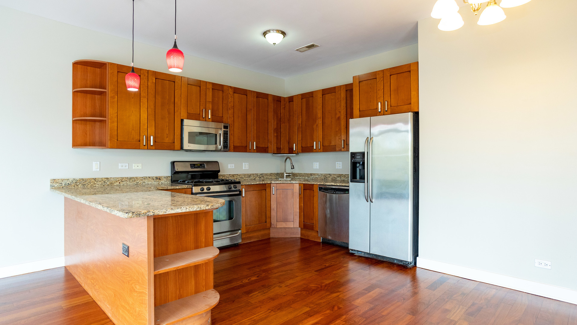 Undisclosed Address Chicago, IL 60645 - Photo 7 of 18 a kitchen with granite countertop wooden floors and stainless steel appliances
