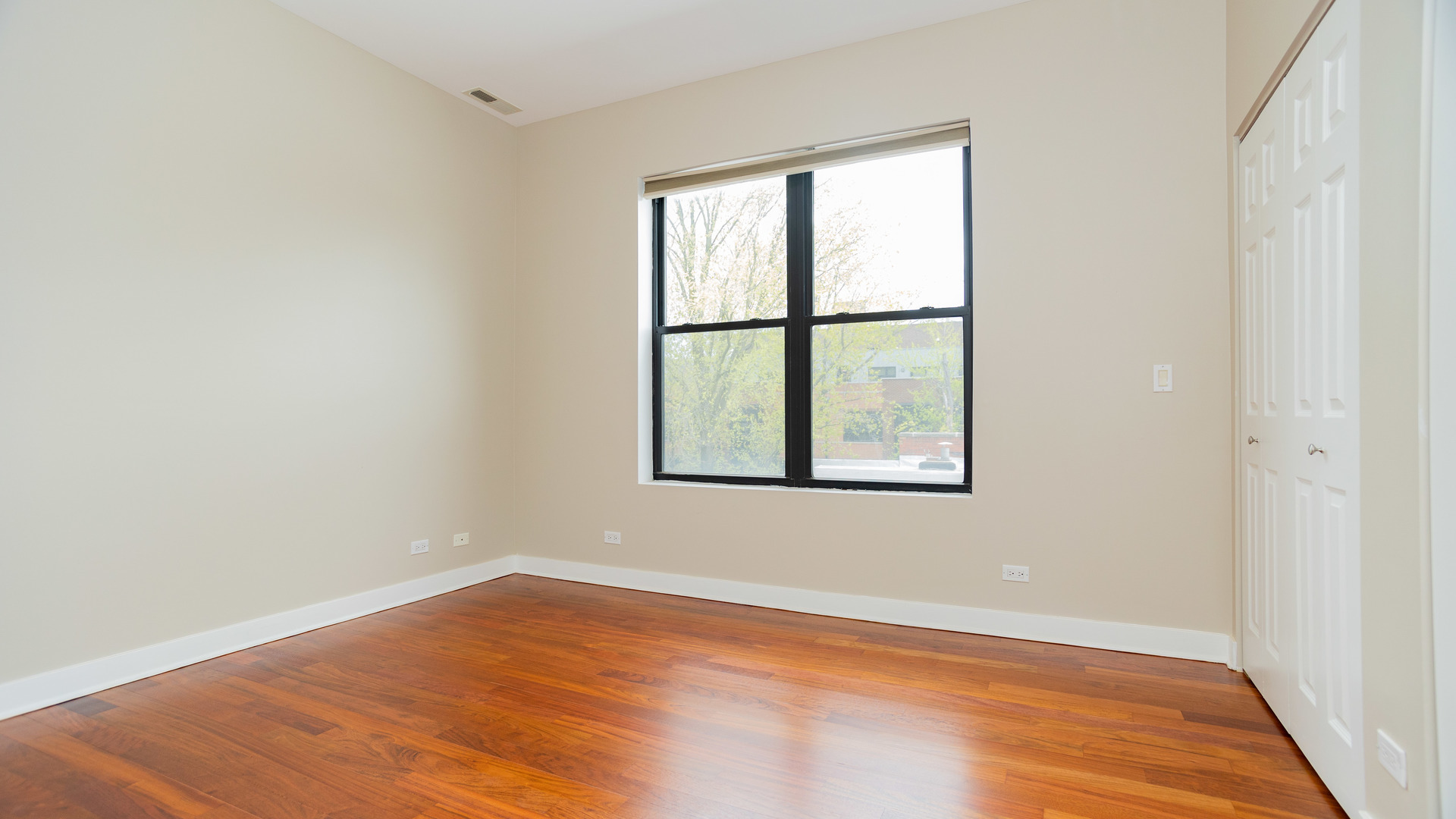 Undisclosed Address Chicago, IL 60645 - Photo 8 of 18 an empty room with wooden floor and windows