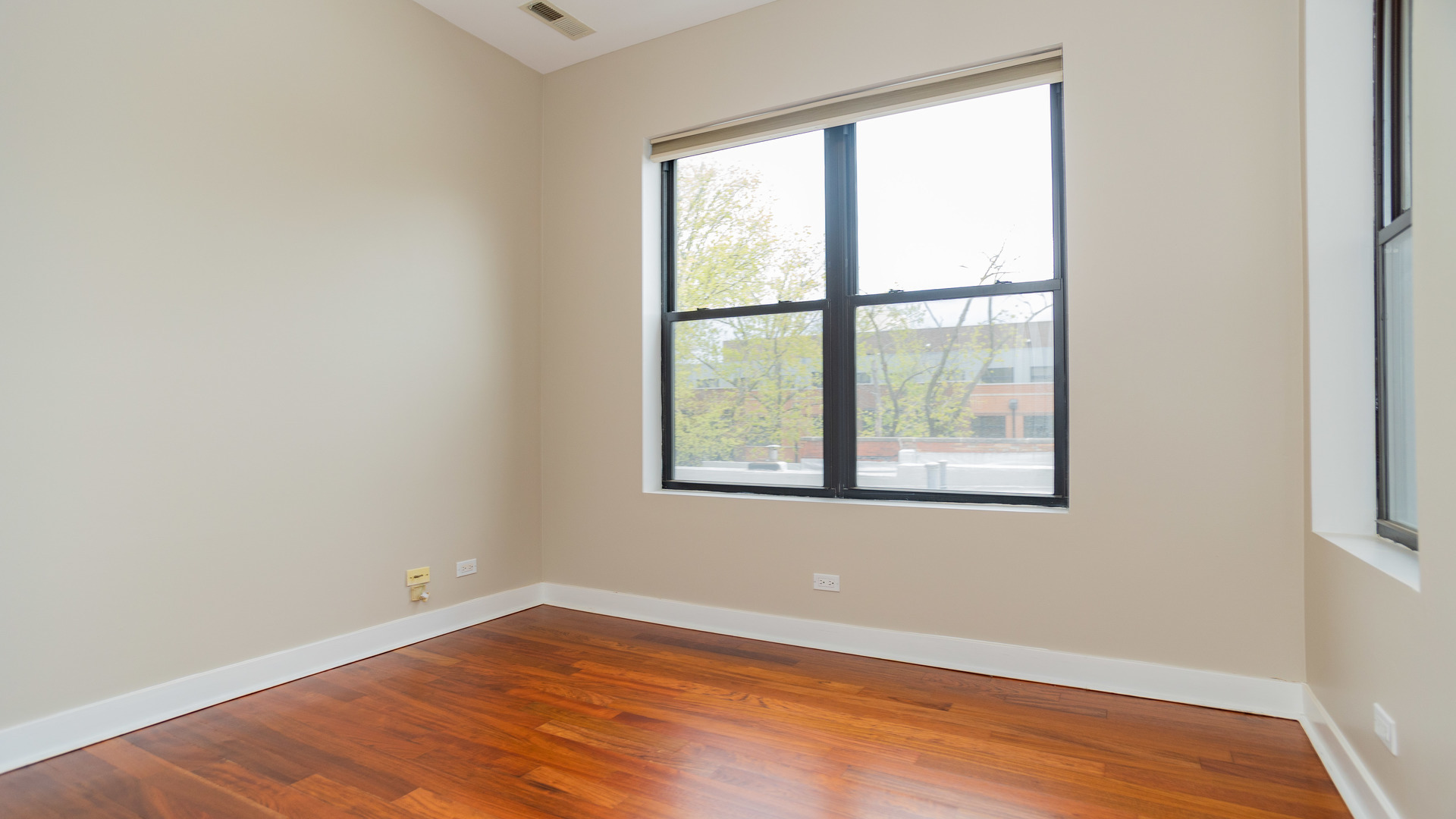 Undisclosed Address Chicago, IL 60645 - Photo 10 of 18 an empty room with wooden floor and windows