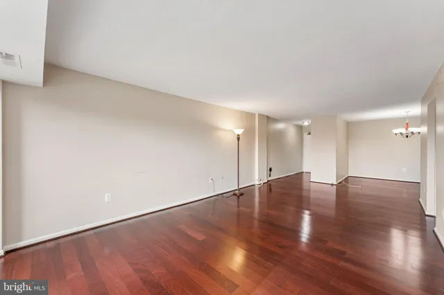 a view of a room with wooden floor and chandelier