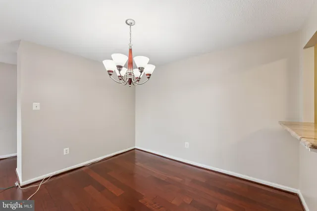 a kitchen with granite countertop wooden cabinets and stainless steel appliances
