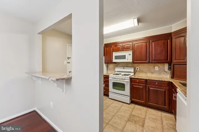 a kitchen with stainless steel appliances granite countertop a stove and a refrigerator