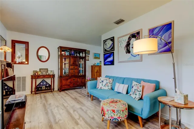 a living room with furniture a rug and a window