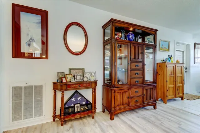 a bedroom with a bed and a lamp on dresser