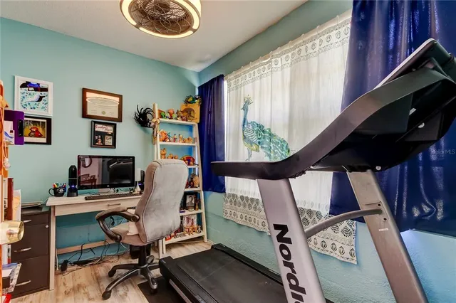 a book shelf with books on the wall and a mirror
