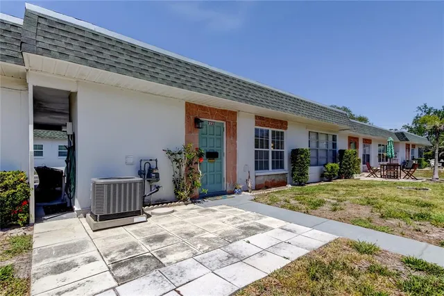 a living room with furniture a bookshelf and a window