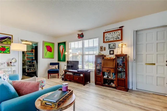 a kitchen with stainless steel appliances granite countertop a table chairs sink and cabinets