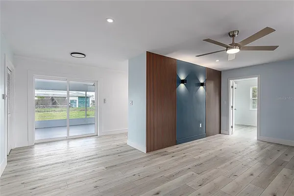 a view of livingroom with hardwood floor and a ceiling fan