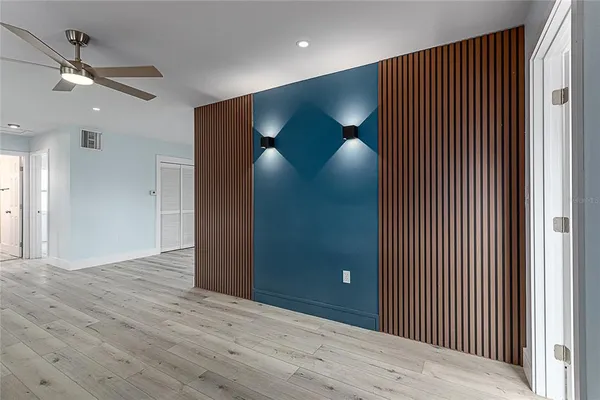 a view of a livingroom with a ceiling fan and wooden floor