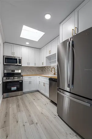 a kitchen with wooden cabinets and stainless steel appliances