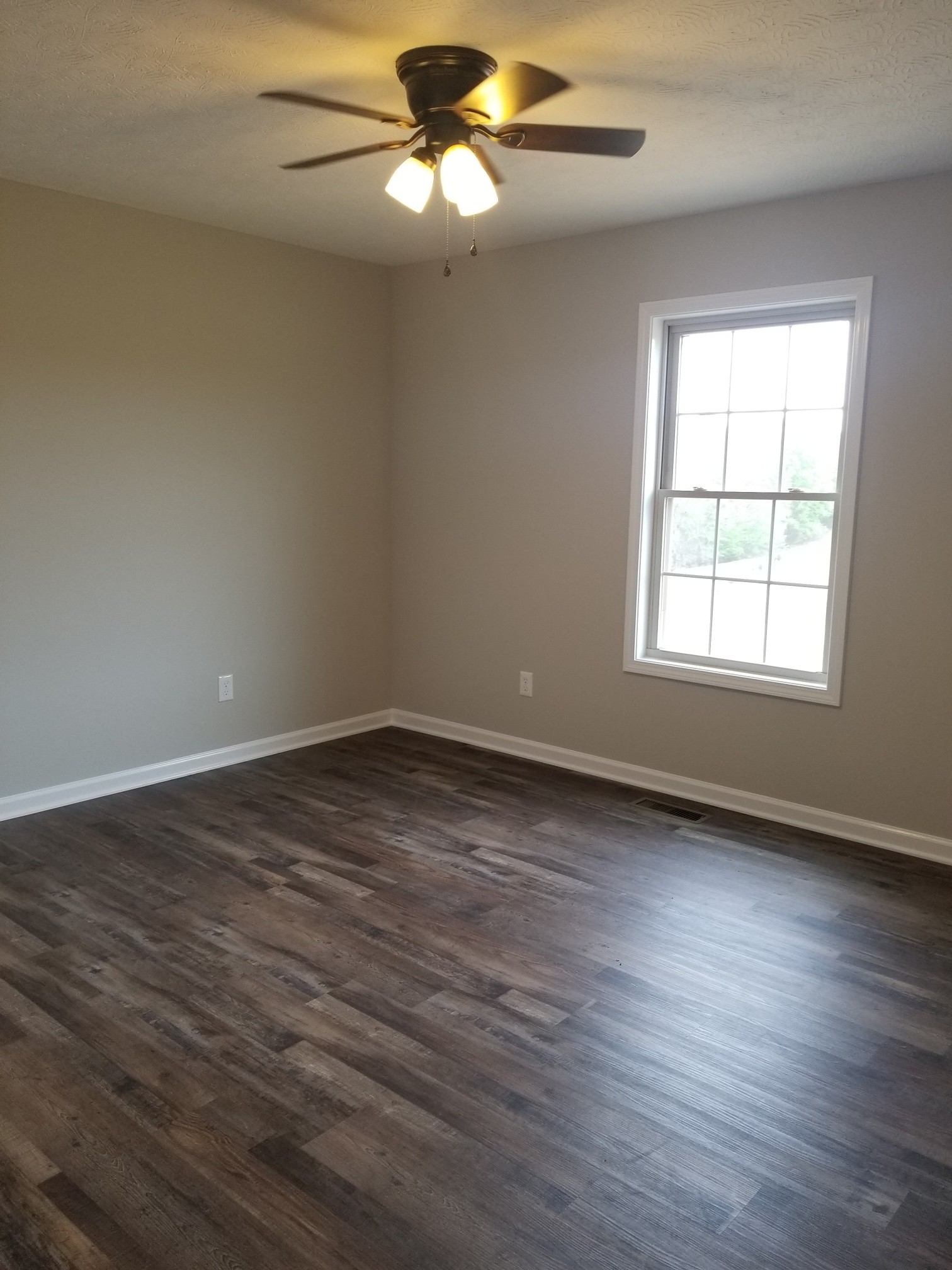 2145 Austin Road Lafayette, TN 37083 - Photo 14 of 21 an empty room with wooden floor fan and windows