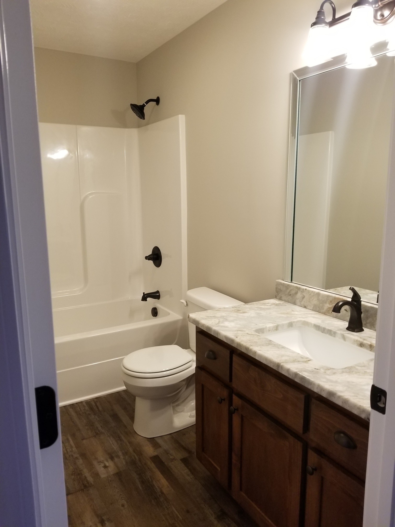 2145 Austin Road Lafayette, TN 37083 - Photo 16 of 21 a bathroom with a tub sink toilet and a mirror