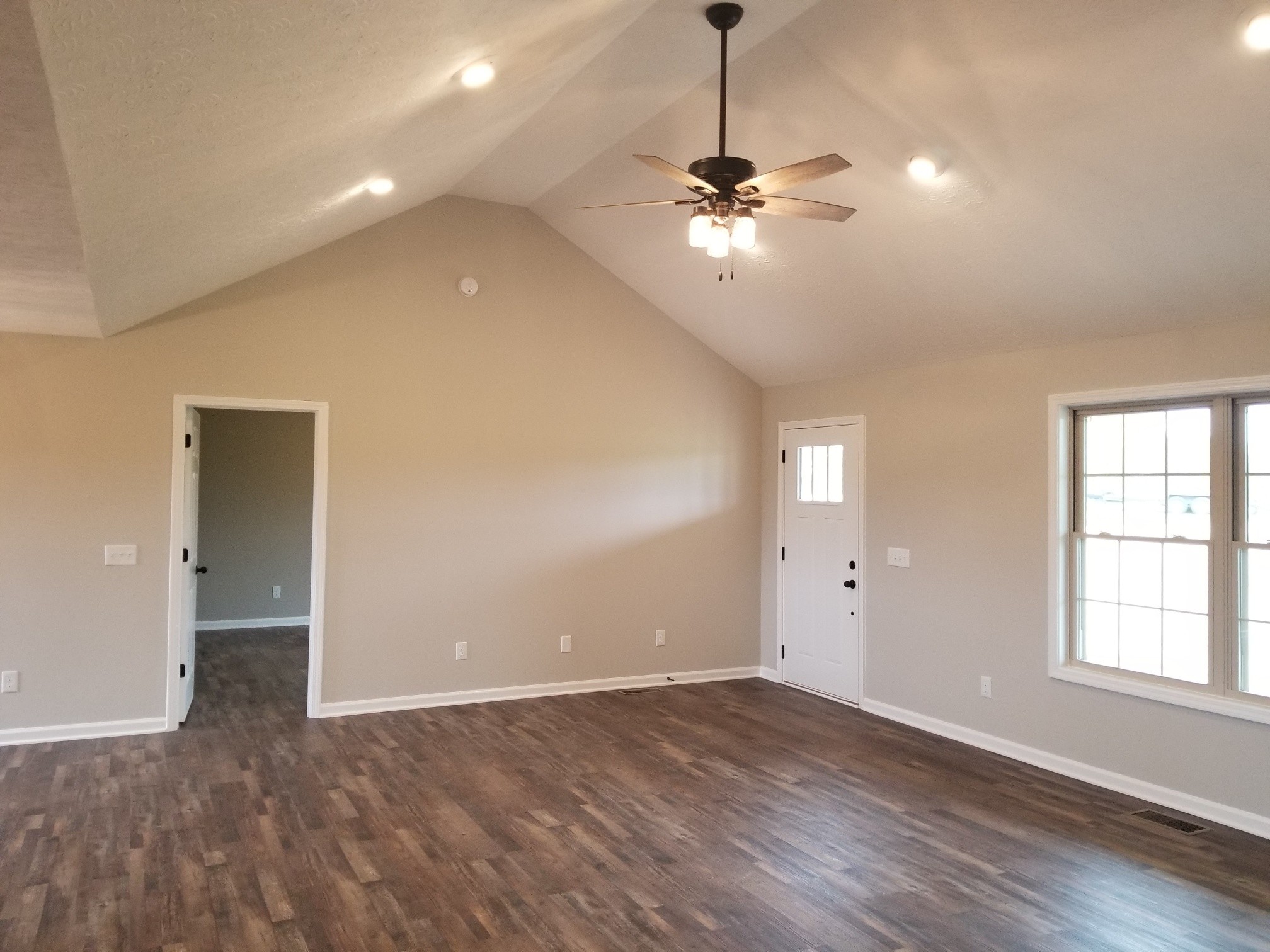 2145 Austin Road Lafayette, TN 37083 - Photo 2 of 21 a view of an empty room with window chandelier fan and fire place